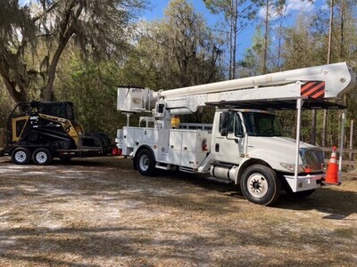 Bucket Truck, Skid Steer and Trailer